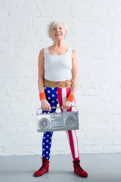 Happy Senior Sportswoman Holding Tape Recorder Smiling Camera — Free Stock Photo