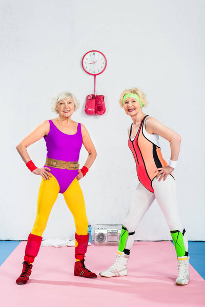 happy sportive senior women training and smiling at camera 