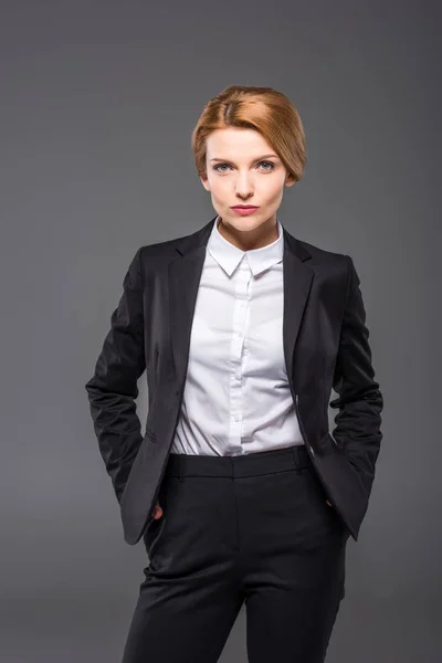 Confident Businesswoman Posing Suit Hands Pockets Isolated Grey — Stock Photo, Image