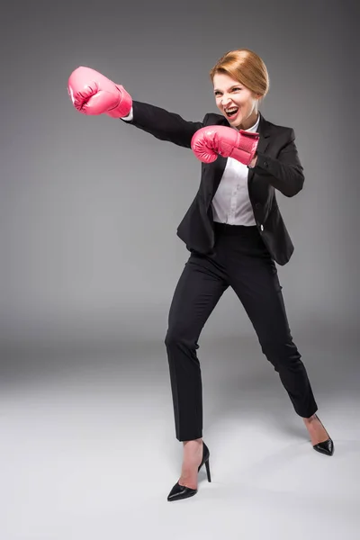 Excited Businesswoman Suit Pink Boxing Gloves Isolated Grey — Free Stock Photo