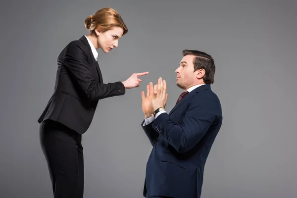 Angry Businesswoman Quarreling Pointing Scared Businessman Isolated Grey — Stock Photo, Image