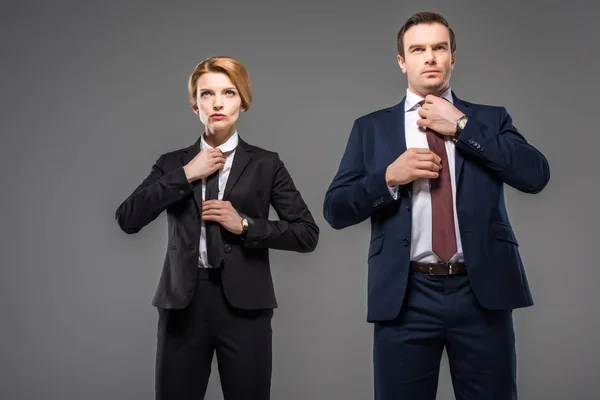 Businesswoman Businessman Fixing Ties Isolated Grey Leader Concept — Stock Photo, Image