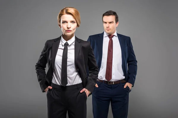 Confident Businesswoman Businessman Suits Standing Hands Pockets Isolated Grey — Stock Photo, Image