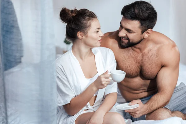 Jovem mulher tomando café na cama — Fotografia de Stock