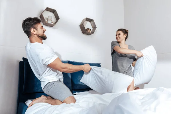 Couple have battle of pillows — Stock Photo