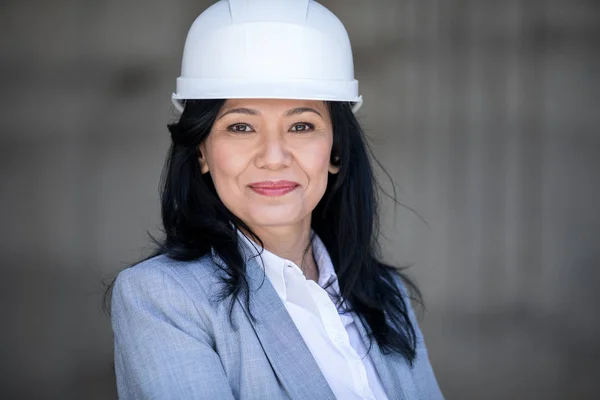 Beautiful businesswoman in hard hat — Stock Photo