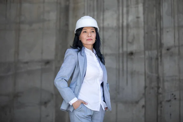 Beautiful businesswoman in hard hat — Stock Photo