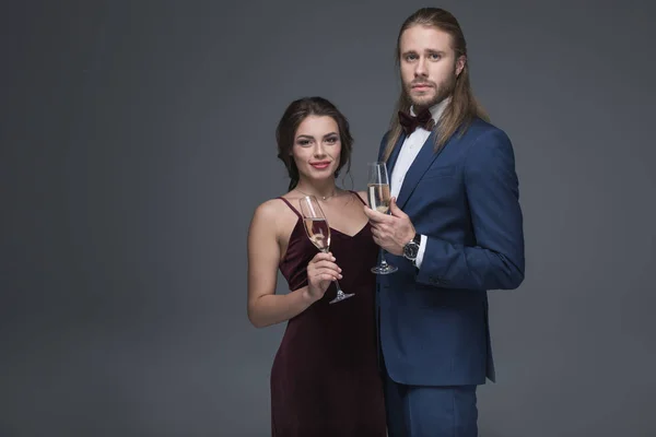 Young couple in evening outfit with champagne — Stock Photo