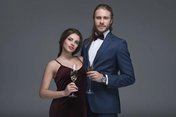 Jeune couple en tenue de soirée avec champagne — Photo de stock