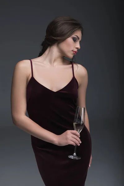 Young lady holding glass of champagne — Stock Photo