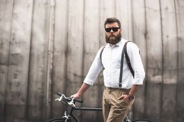 Stylish man standing with bicycle — Stock Photo