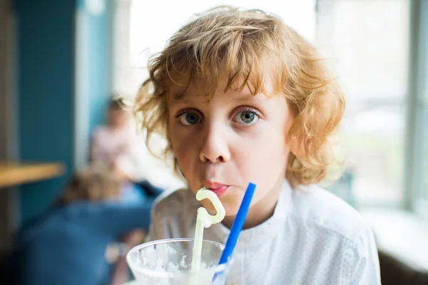 Niño bebiendo batido - foto de stock