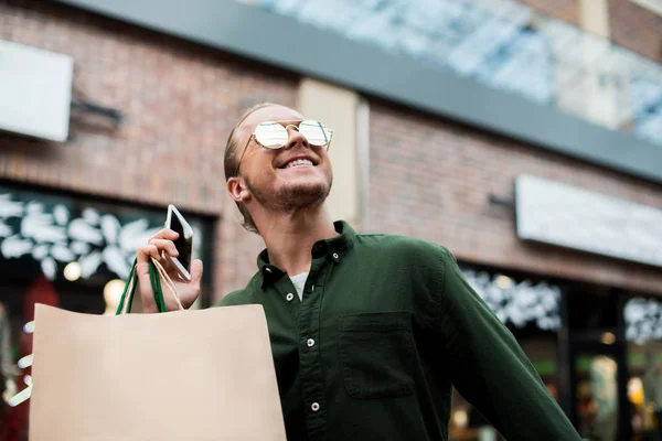 Man with shopping bags on street — Stock Photo