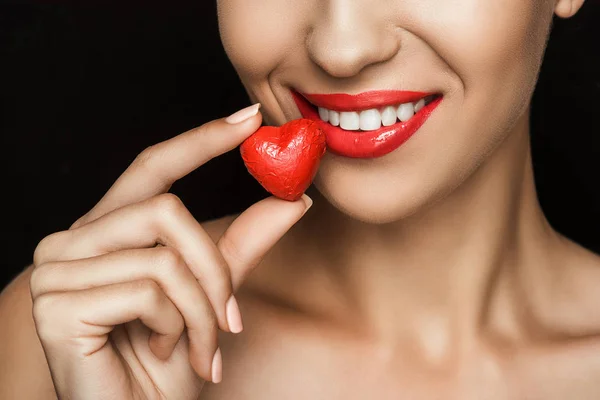 Woman with heart shaped candy — Stock Photo