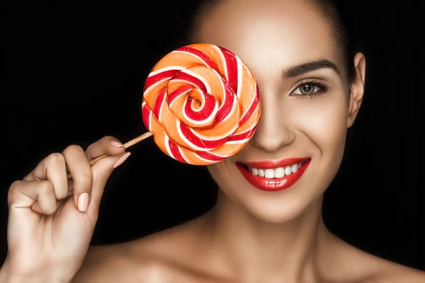 Beautiful woman with lollipop — Stock Photo