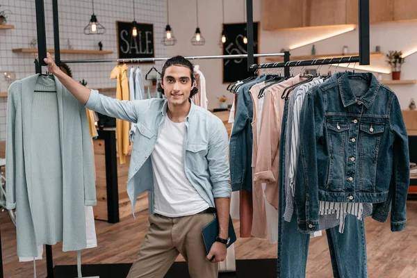 Man with digital tablet in boutique — Stock Photo