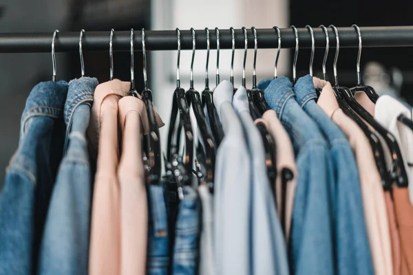 Stylish clothes on hangers — Stock Photo