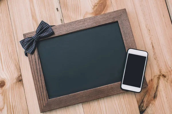 Smartphone and blank frame — Stock Photo