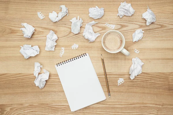 Empty notepad and crumpled papers — Stock Photo