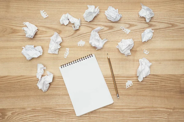 Empty notepad and crumpled papers — Stock Photo