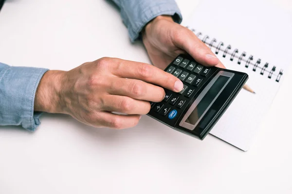 Hands with calculator and notepad — Stock Photo