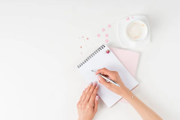 Woman writing in notebook — Stock Photo