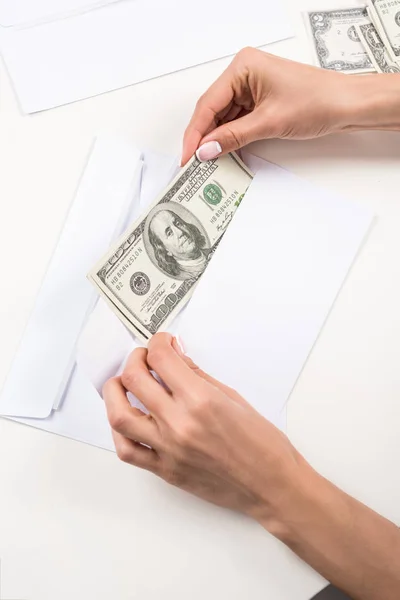 Female hands with dollar banknotes in envelope — Stock Photo