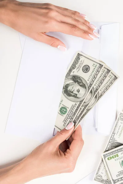 Female hands with dollar banknotes in envelope — Stock Photo