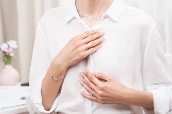 Woman buttoning shirt — Stock Photo