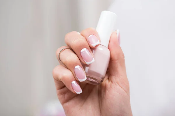 Woman holding nail polish — Stock Photo