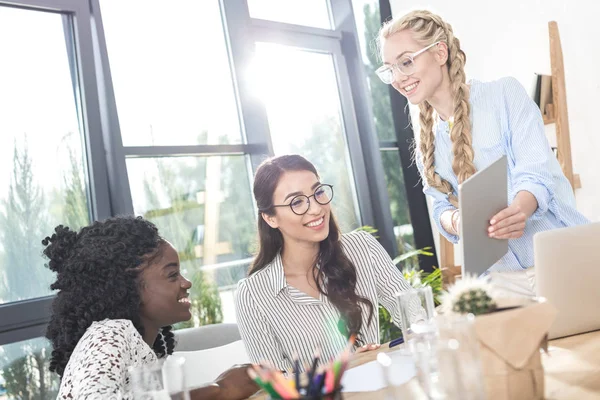 Multicultural businesswomen working with tablet — Stock Photo