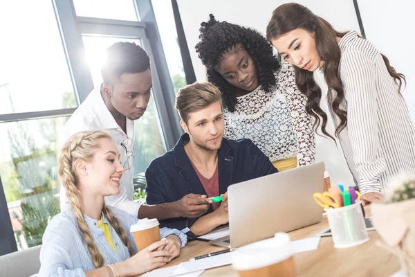 Multiethnic business team with laptop — Stock Photo