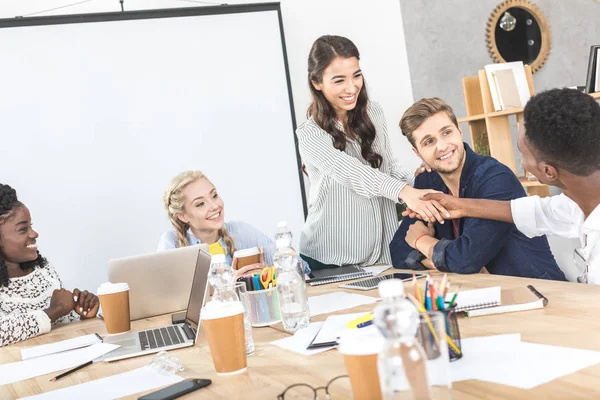 Multiethnic business partners shaking hands — Stock Photo