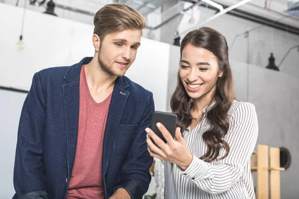 Multicultural business colleagues using smartphone — Stock Photo