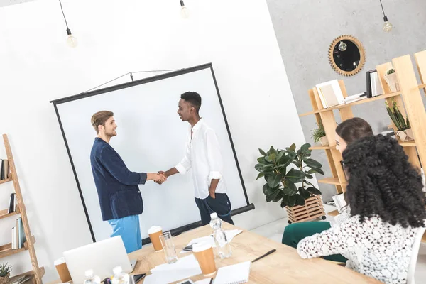 Multiethnic businessmen shaking hands — Stock Photo