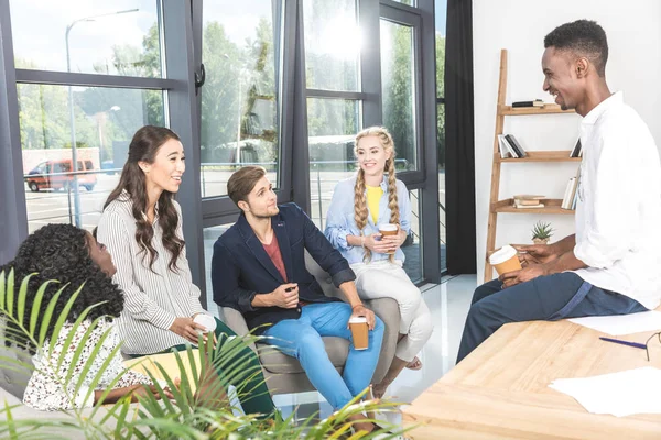 Multiethnic coworkers having coffee break — Stock Photo