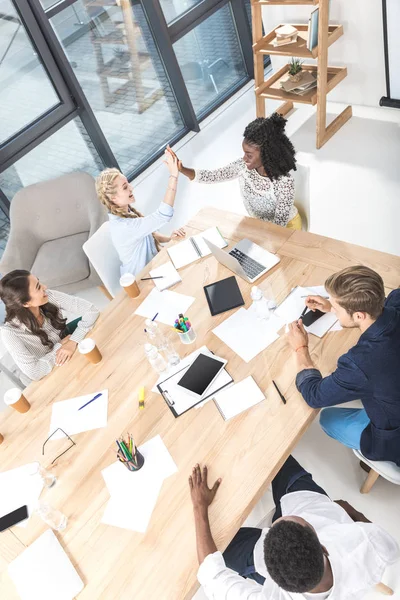 Multicultural businesswomen giving high five — Stock Photo