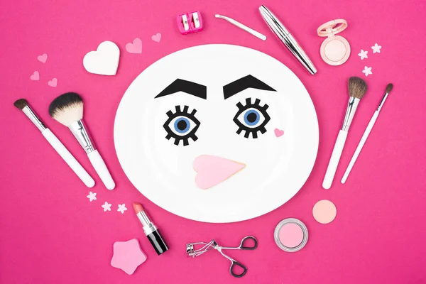 Paper face with makeup on plate — Stock Photo