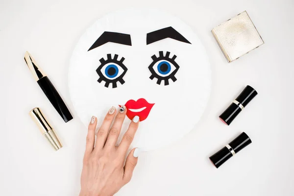 Paper face with makeup on plate — Stock Photo