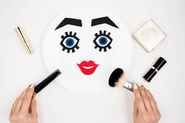 Paper face with makeup on plate — Stock Photo