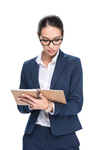 Businesswoman writing in diary — Stock Photo