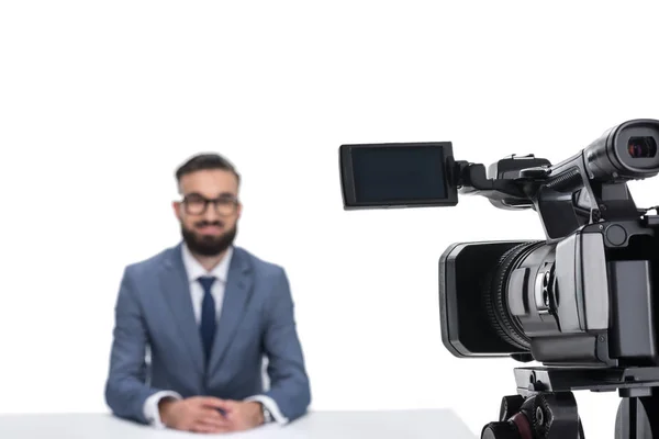 Newscaster sitting in front of camera — Stock Photo