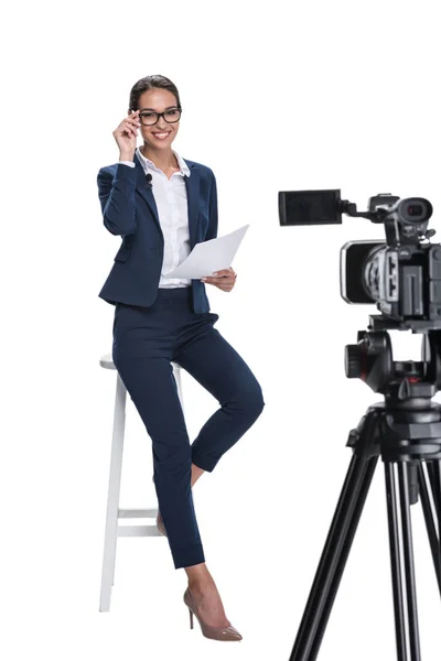 Presentador de noticias sentado frente a la cámara - foto de stock