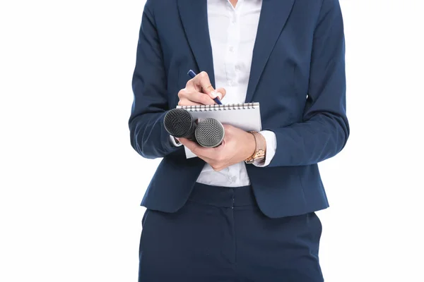Female journalist with microphones — Stock Photo