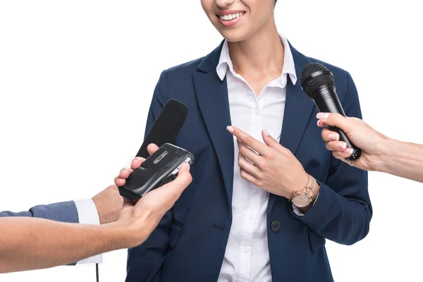 Journalists with microphones interviewing businesswoman — Stock Photo