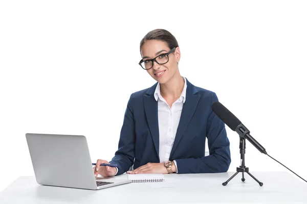 Newscaster with laptop and microphone — Stock Photo