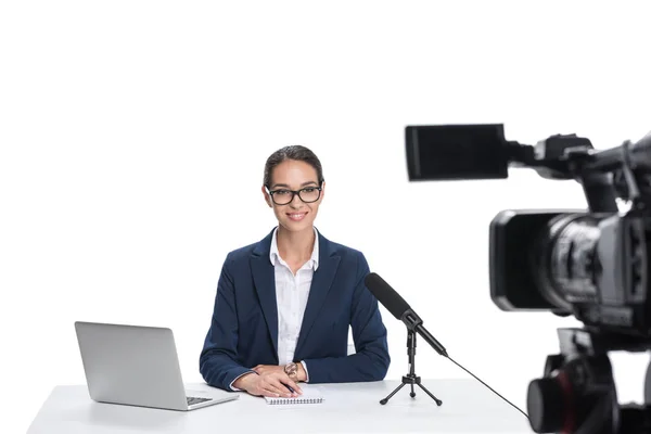 Newscaster with laptop looking at camera — Stock Photo