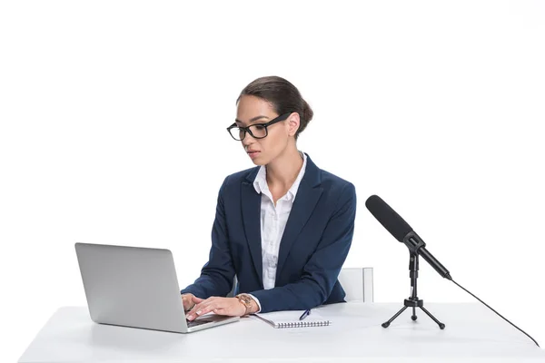 Newscaster with laptop and microphone — Stock Photo