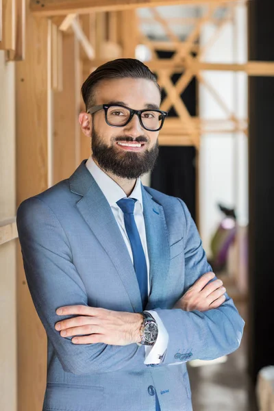 Handsome businessman with crossed arms — Stock Photo