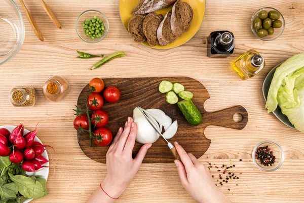 Woman cutting onion — Stock Photo